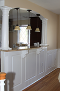 Beaded Raised Panel Wainscoting with fluted pilasters in a Living Room in Bellmore New York NY
