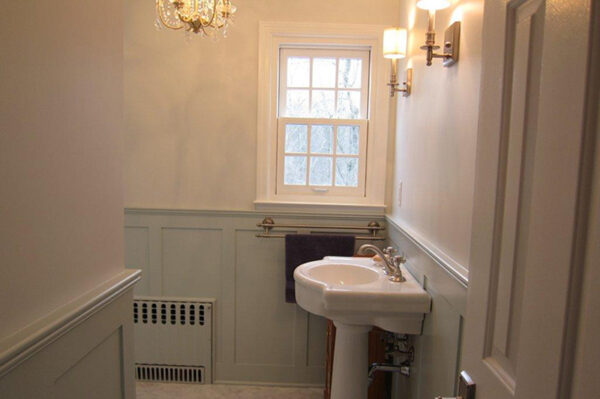Shaker panel in bathroom behind sink and under window