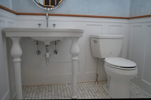 Beaded Recessed Wainscoted powder room. The panel under the sink is customized to accomdate the plumbing.