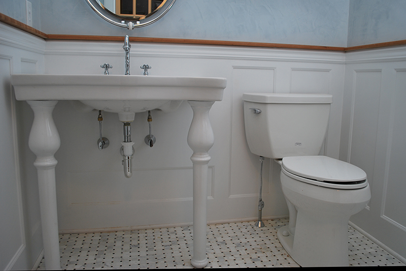 Beaded Recessed Wainscoted powder room. The panel under the sink is customized to accomdate the plumbing.